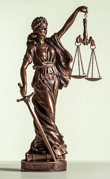 Bronze statue of Justice with sword and scales
